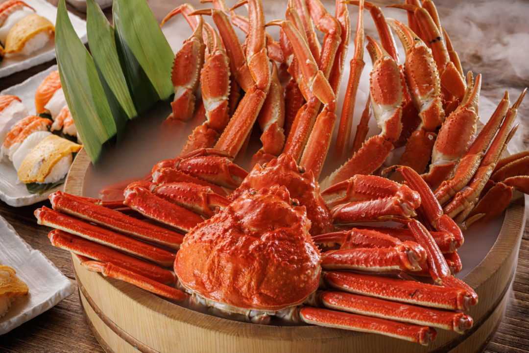 Steamed snow crab legs on a wooden platter