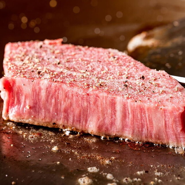 Sizzling Wagyu beef steak searing on hot grill