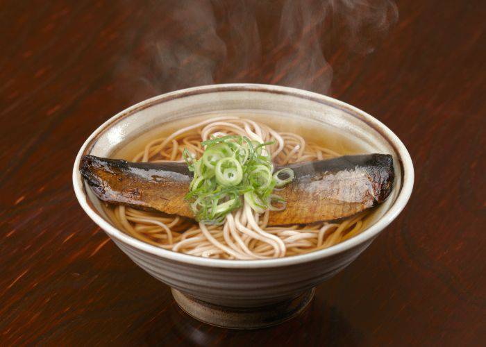 A warming bowl of soba with grilled mackerel atop, still steaming.