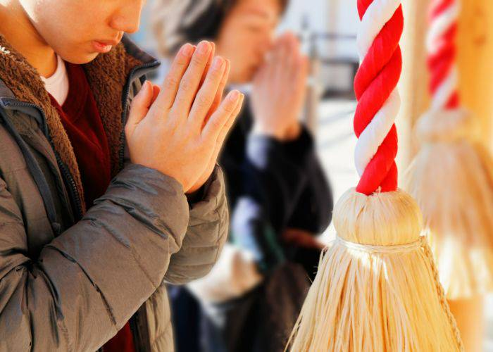 People praying at a Japanese shrine or temple for Hatsumode.