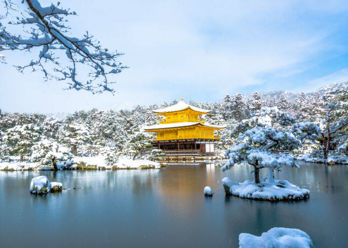 Kinkaku-ji Temple covered in snow during winter in Kyoto.