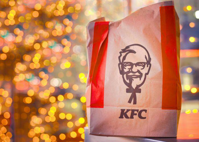 A bag of KFC with a backdrop of festive lights.