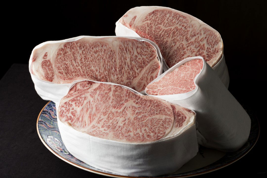 Premium Wagyu beef cuts displayed on an elegant ceramic plate