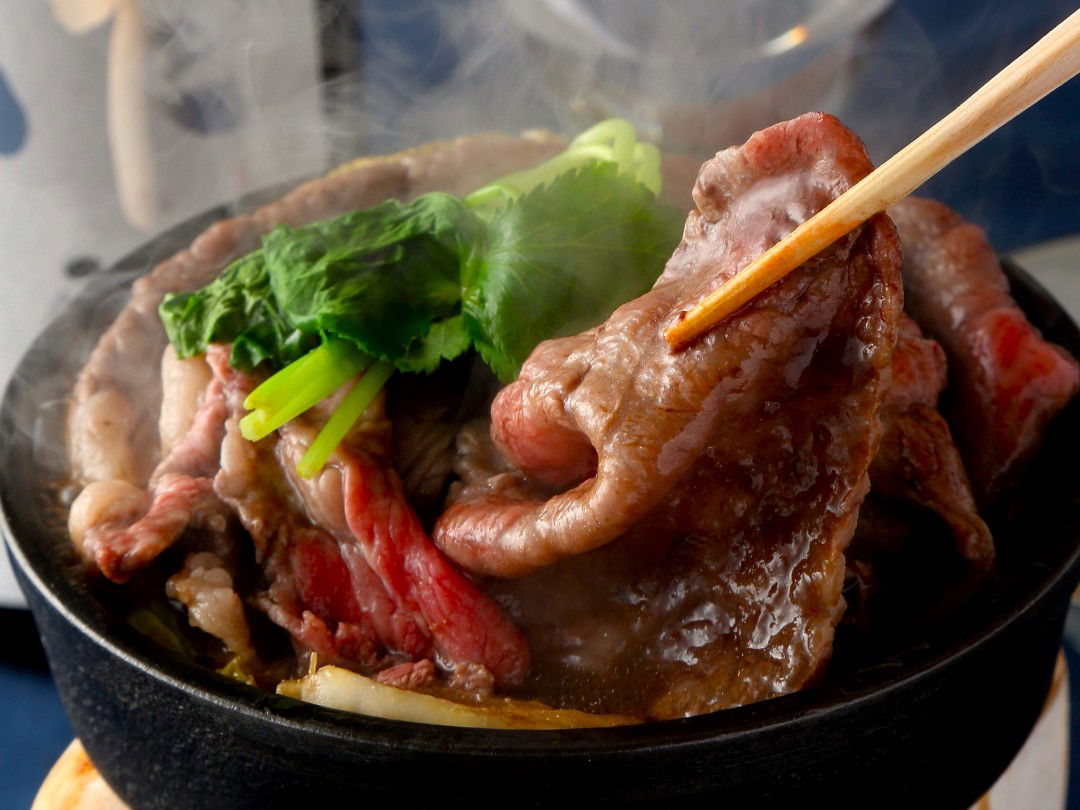 Sizzling beef with greens on a hot plate