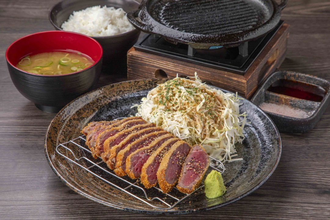 Delicious katsu dish with cabbage and rice in Japanese restaurant