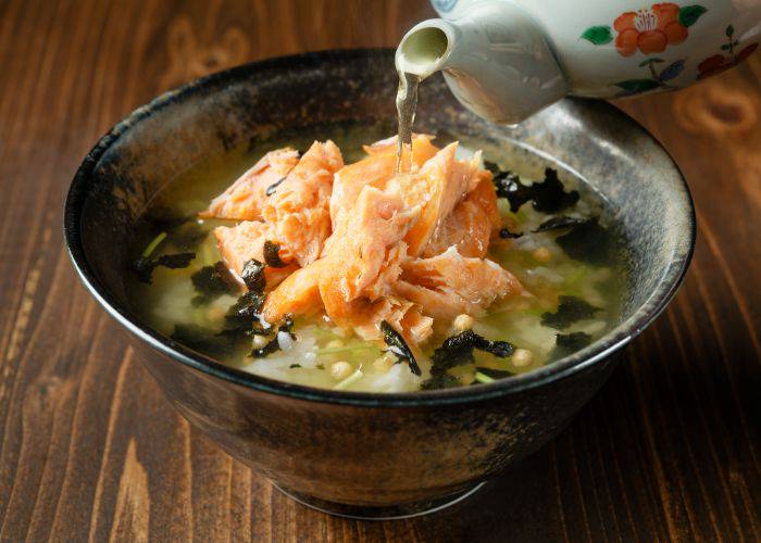 A bowl of salmon ochazuke with tea being poured on top