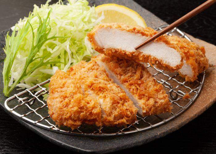 Tonkatsu pork cutlet on a tray with shredded cabbage