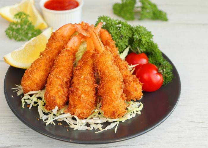 A plate of fried shrimp with vegetables