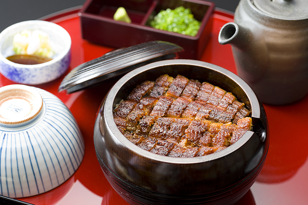 Traditional Japanese grilled eel dish served in lacquered bowl