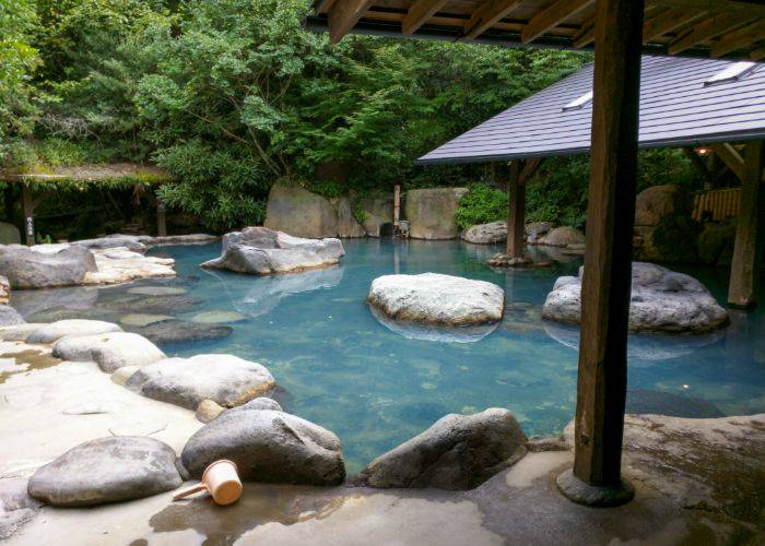 Calming, blue hot springs with a lush natural backdrop.