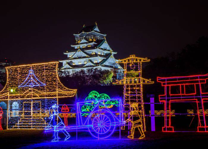 Colorful winter illuminations framing the iconic Osaka Castle.