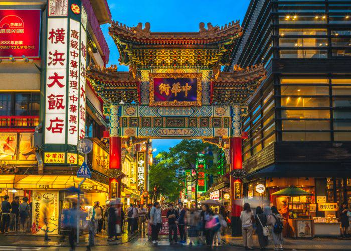 The memorable entrance gate to Yokohama Chinatown, illuminated as night falls.