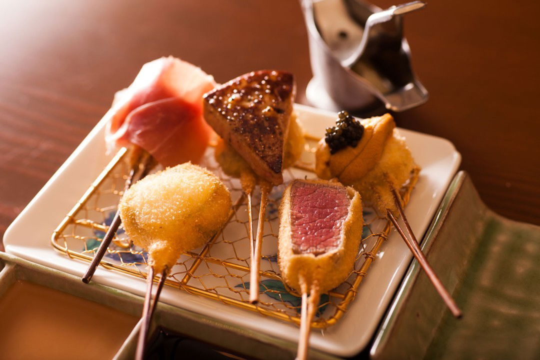 Assorted gourmet skewers on elegant plate for fine dining course