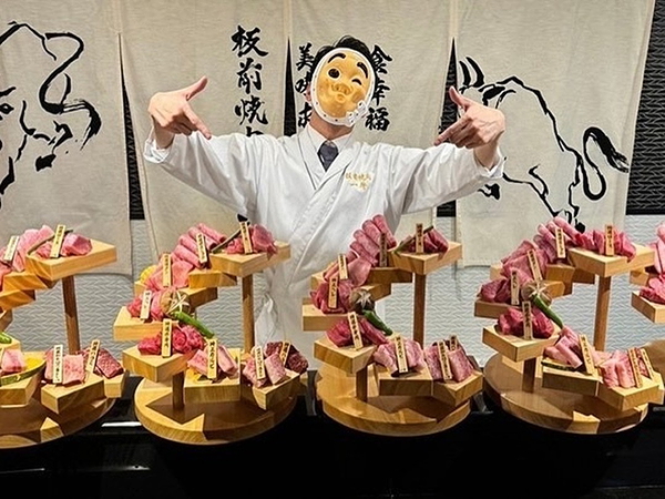 Chef presenting sushi delicacies on wooden stands at Japanese restaurant