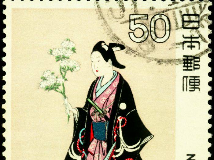 A retro stamp with a woman holding a bouquet of sakura.