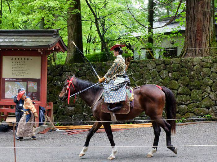 An archer riding horseback as part of the tradition of Yabusame Shinji.