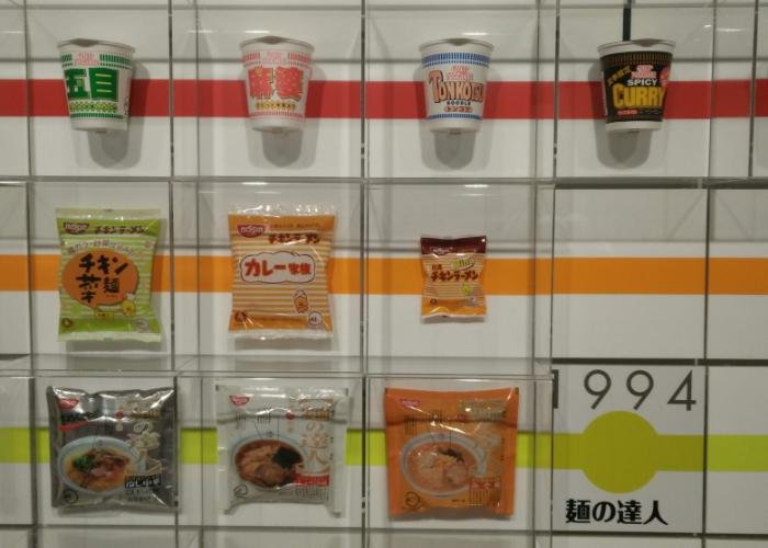 A wall at the Cup Noodles Museum of Osaka shows various types of ramen through the ages