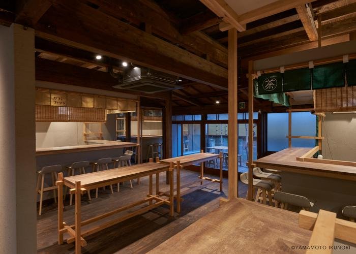 Interior of the Mikan Club cafe in Urasando Garden, with rustic wooden tables and chairs