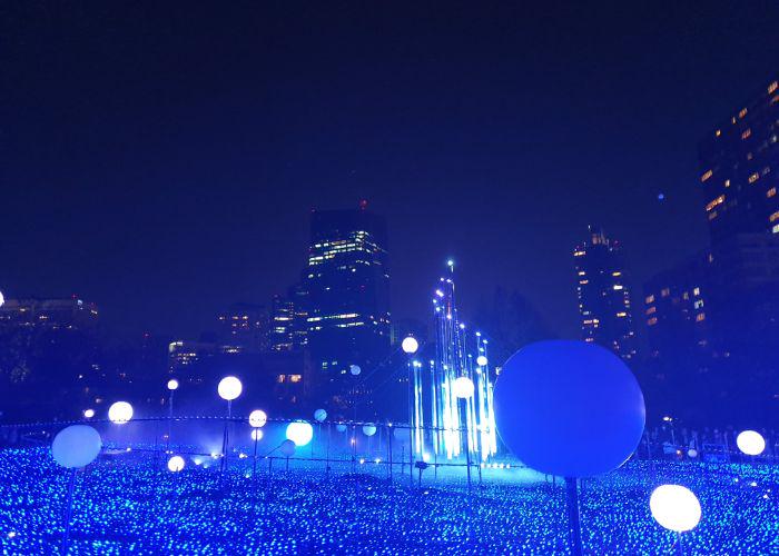 Blue illuminations at Roppongi Hills with a backdrop of the city