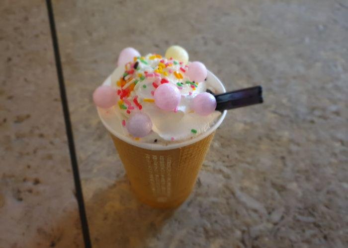Hot Chocolate with whipped cream and multi-coloured sprinkles and sweets on top