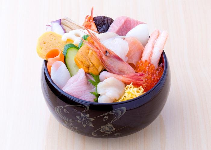 A seafood donburi from Kanazawa, featuring shrimp, uni, tamago, fish roe, and other types of seafood