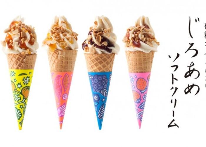 Four clorful ice cream cones topped with nuts