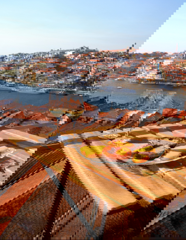 Scenic Porto view with wine and cheese on a rooftop terrace
