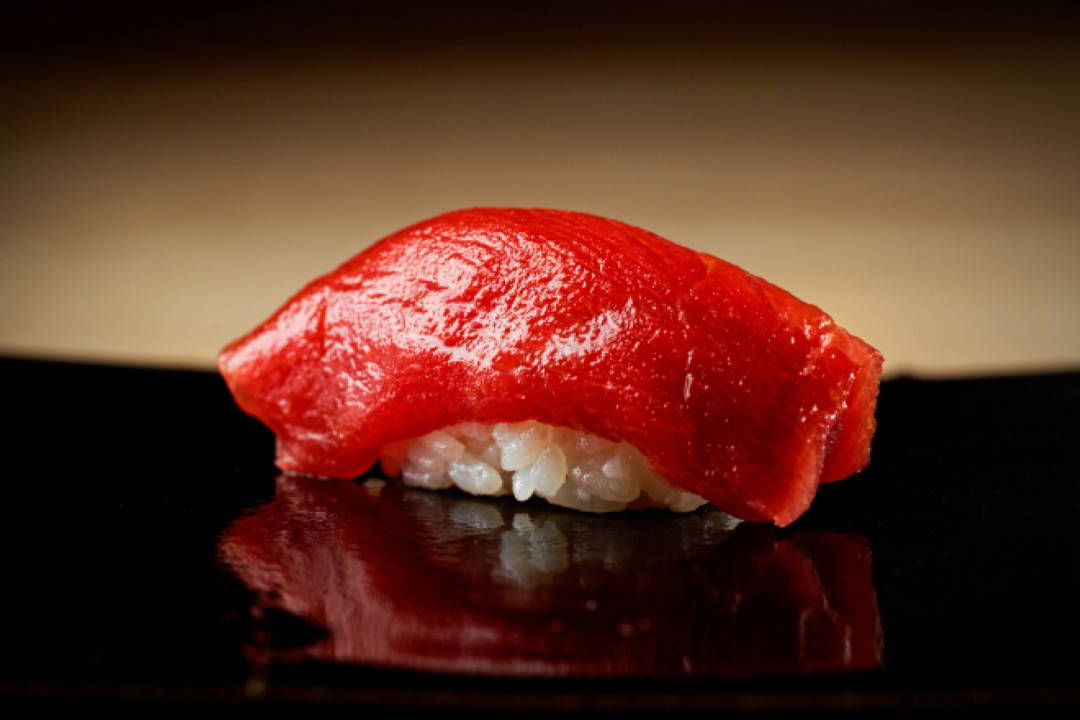 Delicate tuna nigiri sushi on black plate