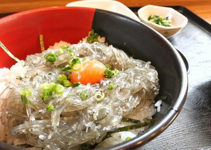 A bowl of sakura eels on a bed of rice
