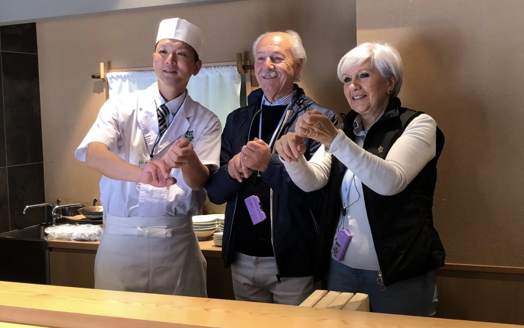Couple learning sushi-making with a skilled chef in Japan