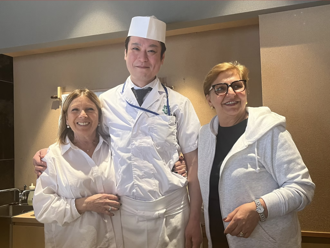 Chef with guests at a Japanese restaurant