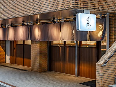 Elegant brick restaurant exterior with warm wooden details