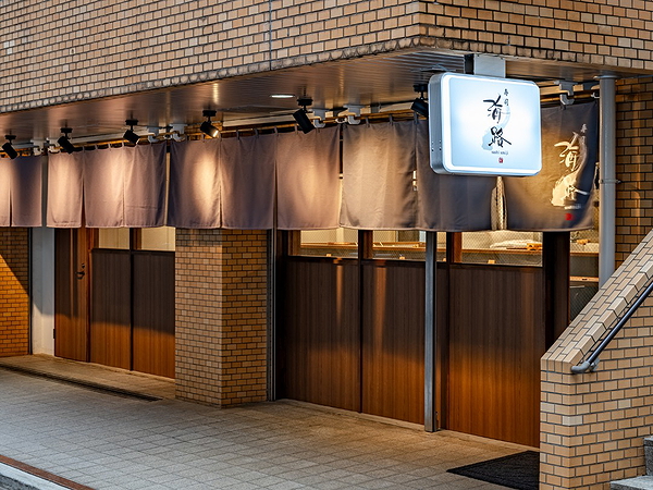Elegant brick restaurant exterior with warm wooden details
