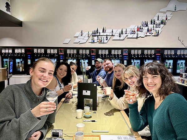 Group enjoying a wine tasting session at a cozy bar