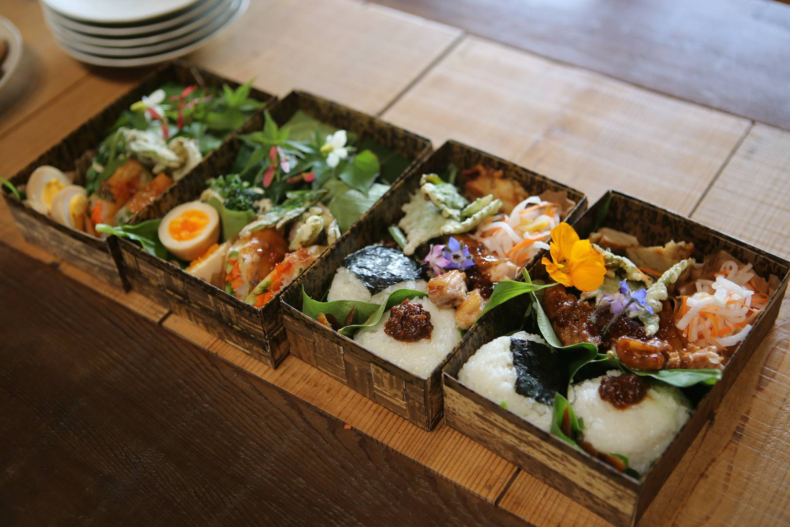 Traditional Japanese bento boxes with assorted decorative dishes