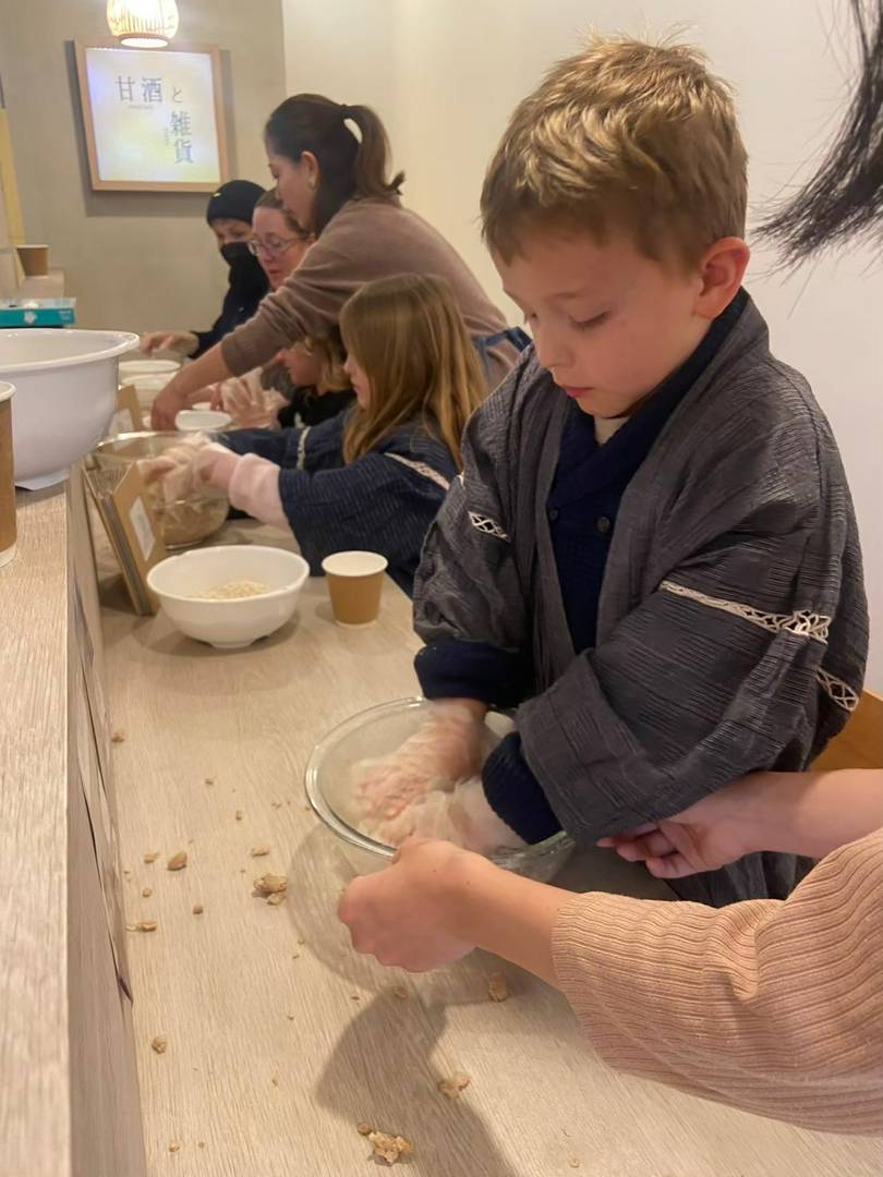 Children making traditional Japanese rice cakes in a cultural workshop.