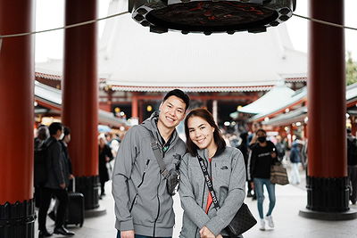 Happy couple exploring historic Asakusa Temple grounds in Tokyo