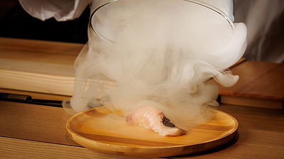 Elegant sashimi with dramatic smoke presentation at fine dining restaurant