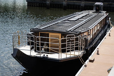 Elegant canal boat moored at dock, ideal for dining experiences