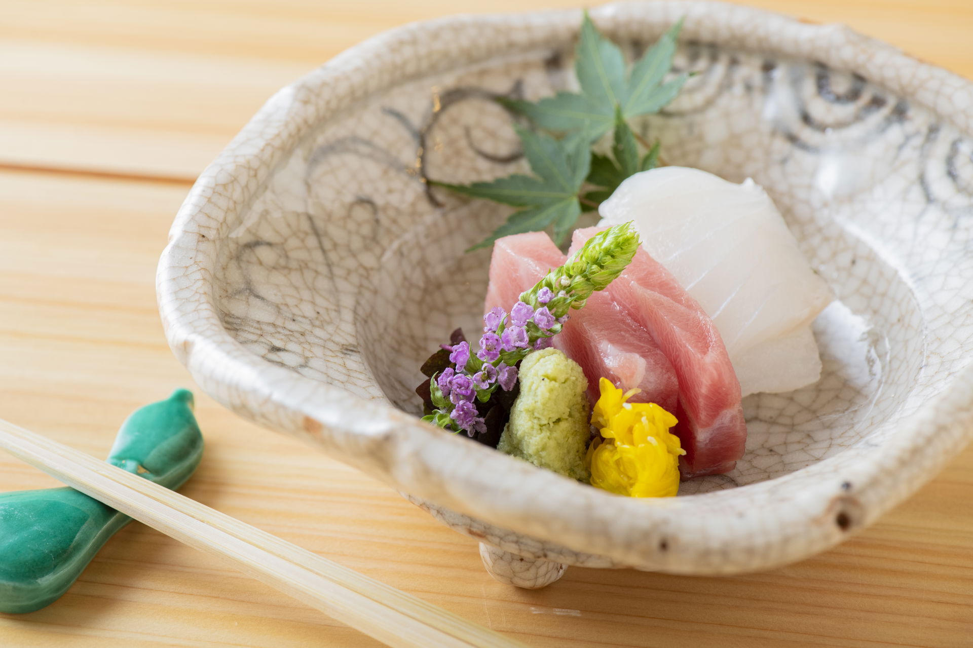Elegant sashimi dish with fresh tuna and wasabi garnish