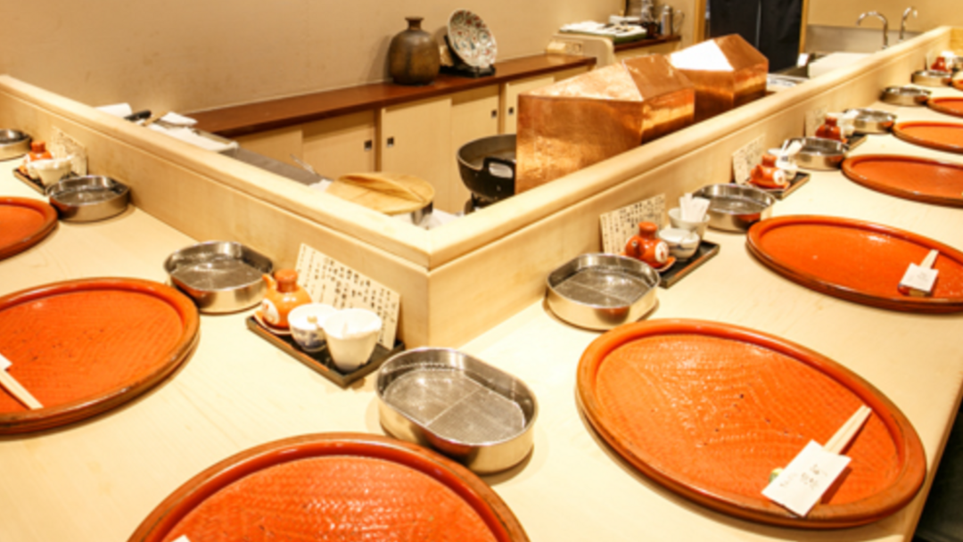 Traditional Japanese course meal setting with empty dishes and trays.