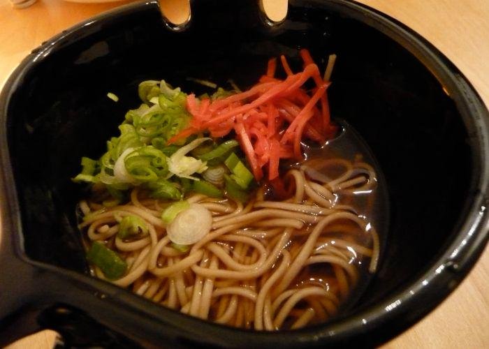 A bowl os Toshikoshi Soba with some pickled ginger and spring onions on top