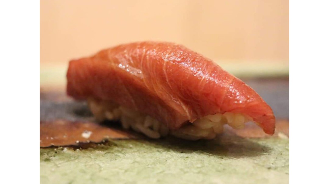 Succulent tuna sushi on a bed of rice highlighting a gourmet menu course.