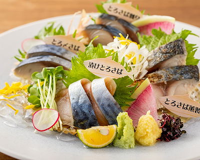 Elegant platter of fresh sushi with colorful garnishes and greens