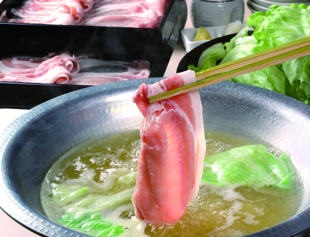 Fresh shabu-shabu pork slice in hot pot with lettuce