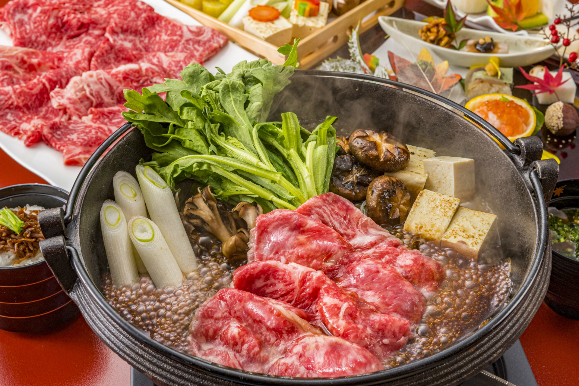 Sukiyaki hot pot with fresh vegetables and beef slices