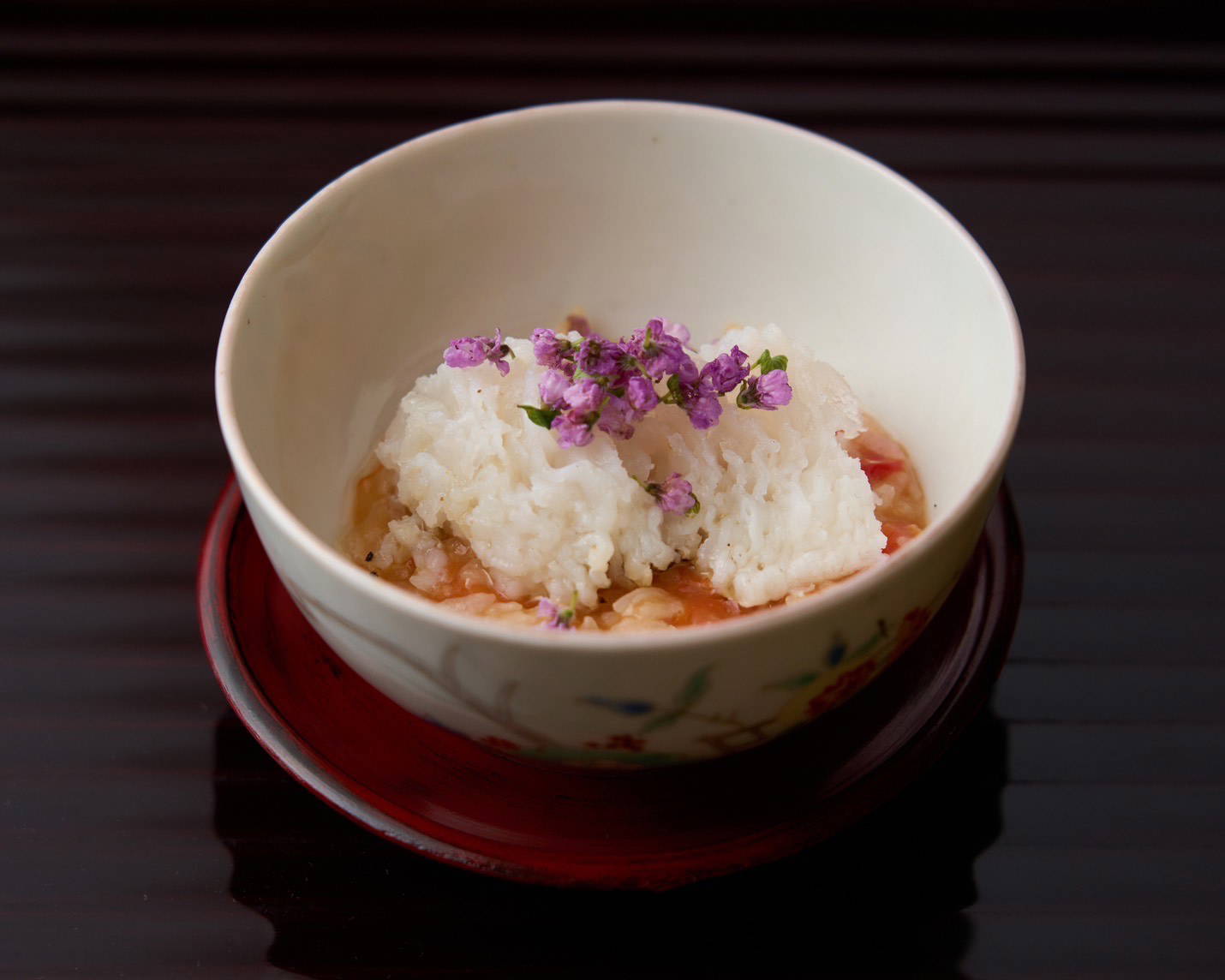 Gourmet rice dish with edible flowers in elegant white bowl