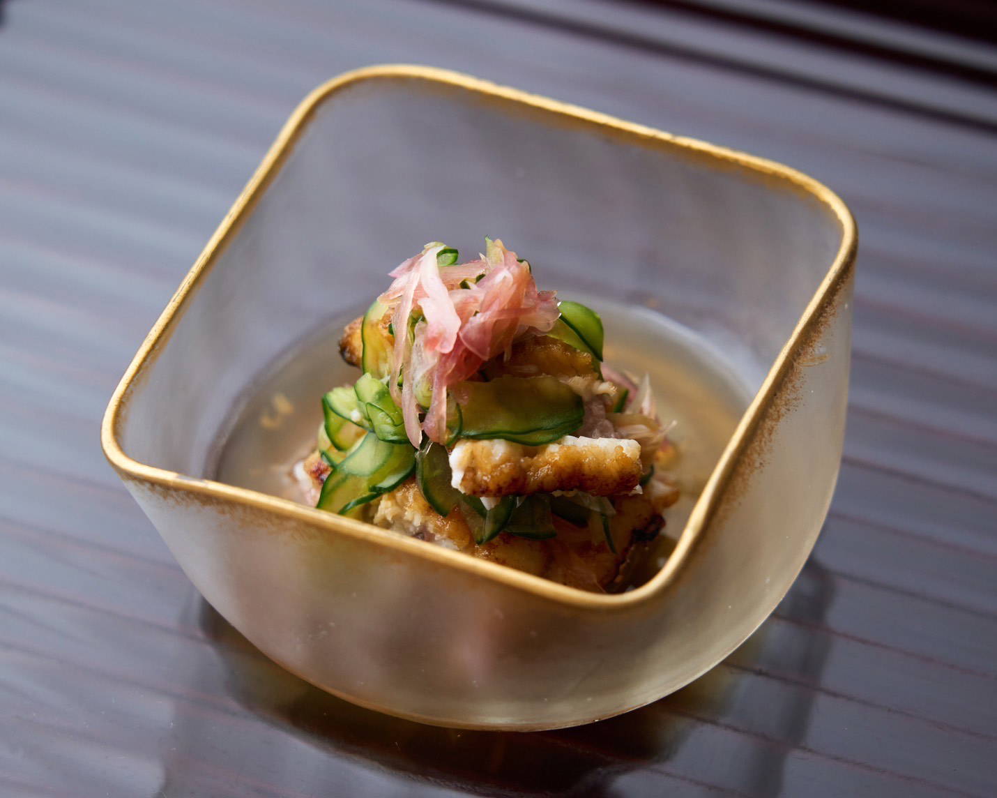 Elegant Asian dish with cucumbers and pickled ginger in glass bowl