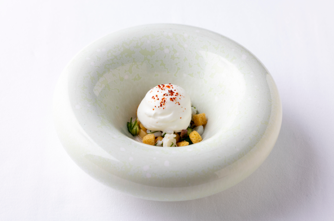 Elegant starter dish featuring creamy mousse and herbs