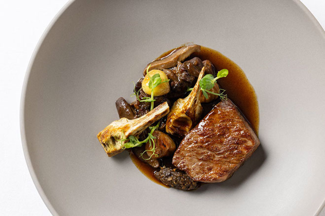 Gourmet entree with seared beef and roasted vegetables